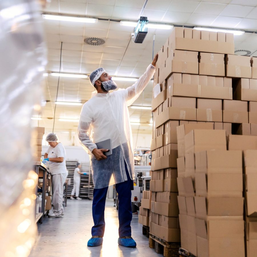 A,Dedicated,Inspector,In,A,White,Sterile,Uniform,Is,Standing